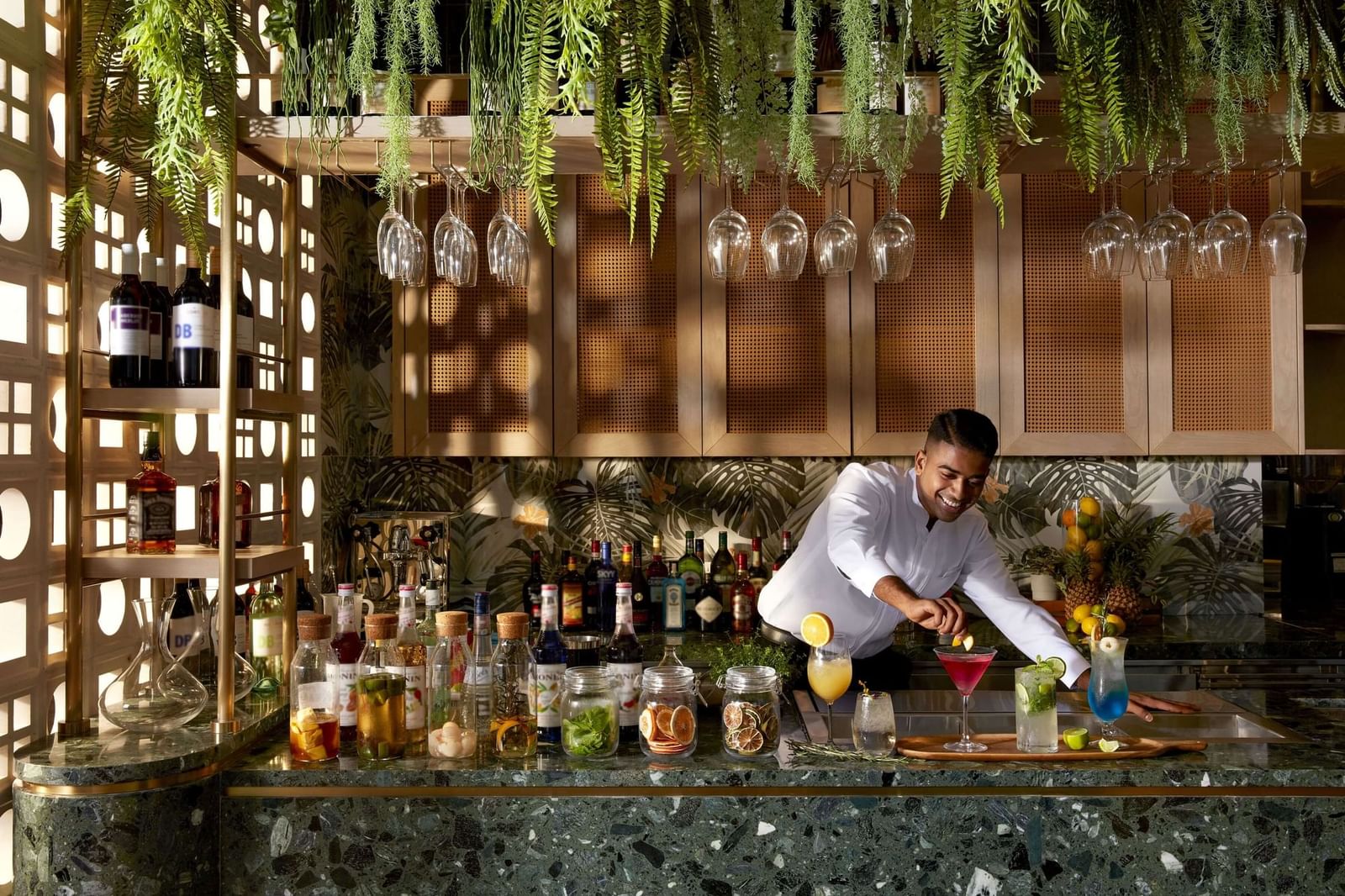 Bartender preparing cocktails at the Verandah bar counter